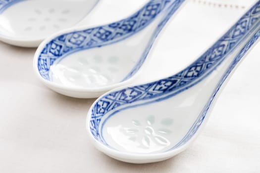 Porcelain chinese spoon with blue hand painted decoration.