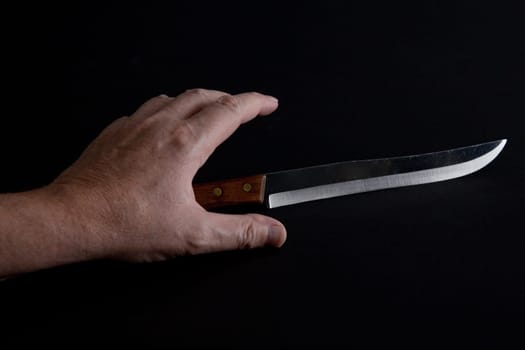 Hand reaches for a bread knife