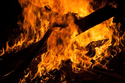 Large campfire in which boards burn
