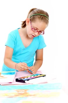 Schoolgirl painting with watercolor