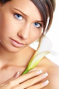 Beautiful young girl with flower against white background