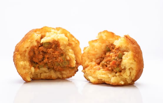 Sicilian rotisserie. Arancina with ragu and peas divided into two.
