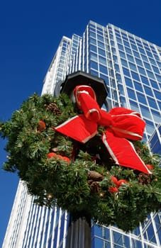 Wreath on public lamppost in front of business building