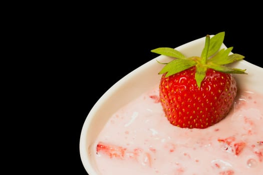 fresh strawberry with  cream . Black background.