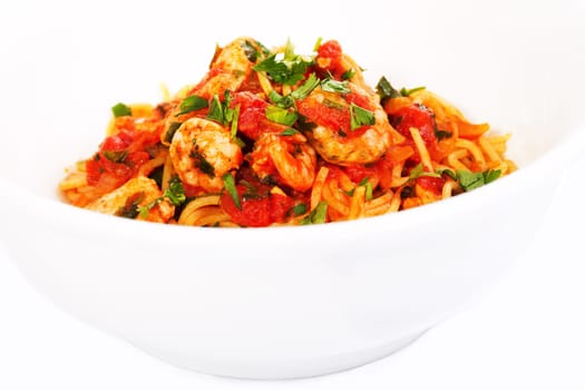Spaghetti tomato seafood dish in white bowl
