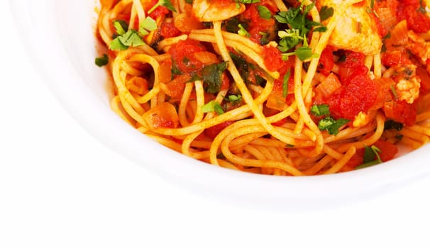 Spaghetti tomato seafood dish in white bowl from top view
