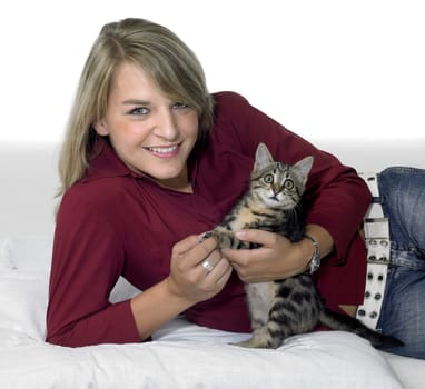 cute girl holding a small kitten in light back