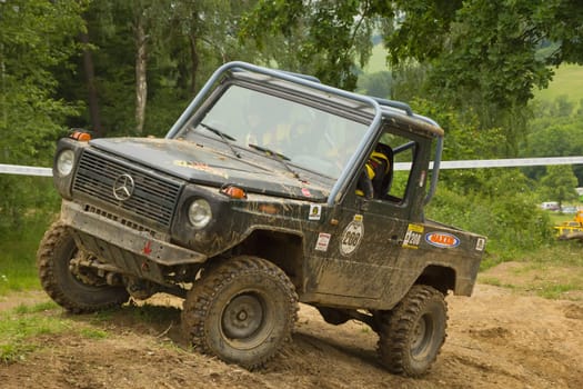 MOHELNICE, CZECH REPUBLIC - JUNE 10. Unidentified racer at blue off-road car on a steep slope in the "SHOCK CUP Trial 2012"" on June 10, 2012 in the town of Mohelnice, Czech Republic."