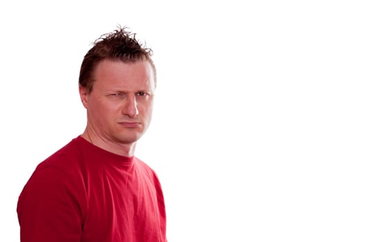Man in red T-shirt looking with skepticism