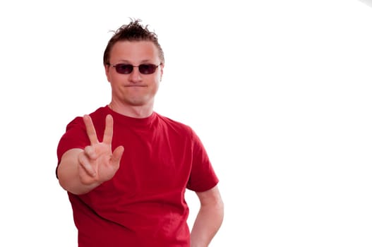 Man with grin holding hand forward with two fingers for peace hand signal