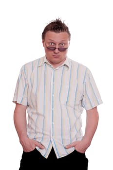 Man with sunglasses and both hands in trouser pockets and skeptical look