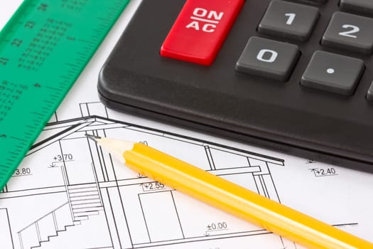 Part of architectural construction plan  with pencil,calculator and ruler
