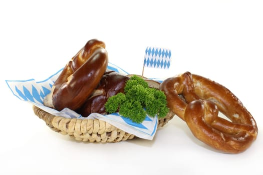 Pretzel pastries with parsley against a white background