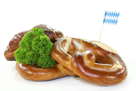 Pretzel pastries with parsley against a white background