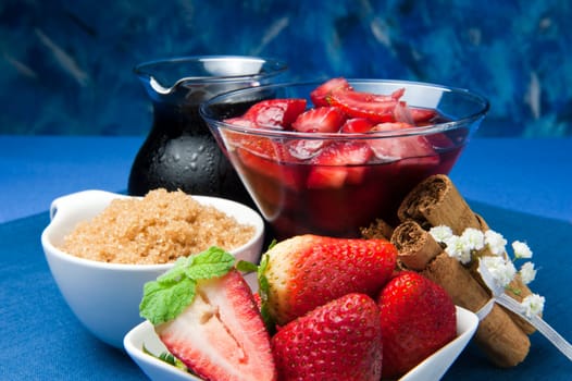 strawberries with red wine, cinnamon and brown sugar on a colore