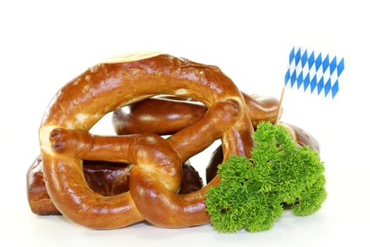 Pretzel pastries with parsley against a white background