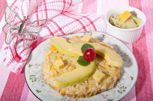 Rice pudding with avocado on a pink background
