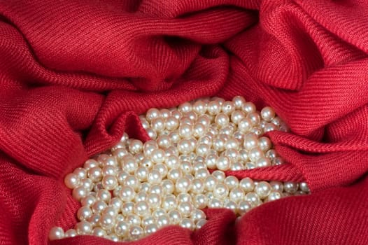 pearls scattered on a colored background fabric
