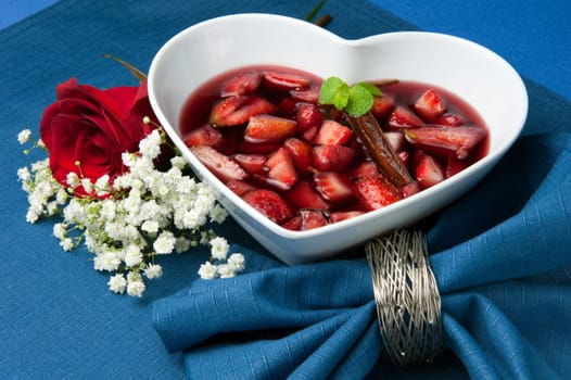 strawberries with red wine, cinnamon and brown sugar on a colore