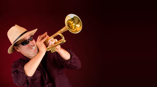 Trumpet Player trumpeting an announcement on a banner with copy space.