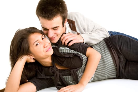 A young couple are lying down on the floor