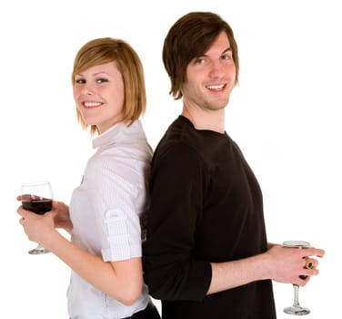 While standing back to back, a young couple are having red wine.