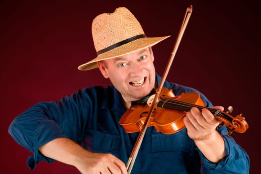 A man is playing country music on the fiddle.