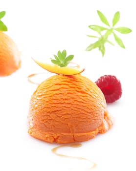 Single scoop of a colourful orange tropical mango icecream dessert on a white background