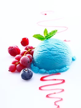 Creamy blueberry icecream with drizzled syrup and an accompaniment of fresh redcurrants and raspberries
