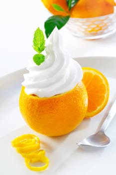 Juicy refreshing orange topped with twirled softserve icecream or whipped cream