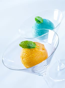 Balls of colourful Italian icecream in stylish elegant individual glass cocktail glasses