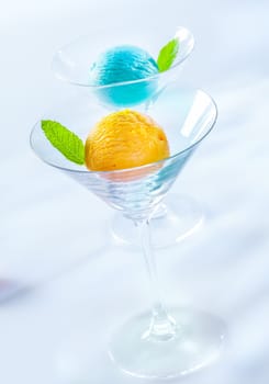 Elegant cocktail glasses with individual servings of balls of colourful Italian icecream