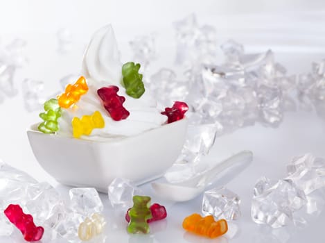 Cold Frozen yogurt Dessert served with ice cubes and brightly gummi bears