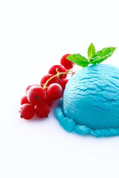Heavy colored blue cyan icecream ball with red currants isolated on white background