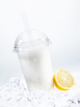 Tangy lemon boba tea with tapioca pearls in a covered glass chilled on ice