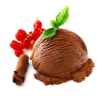 Delicious chocolate icecream garnished with mint accompanied with redcurrants and a chocolate shaving