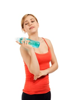 Young sporty woman with a bottle of water against a white background
