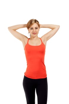 Young sportswoman stretching in front of white background