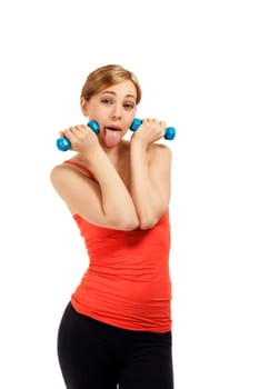 Young sportswoman with dumbbells making faces against white background