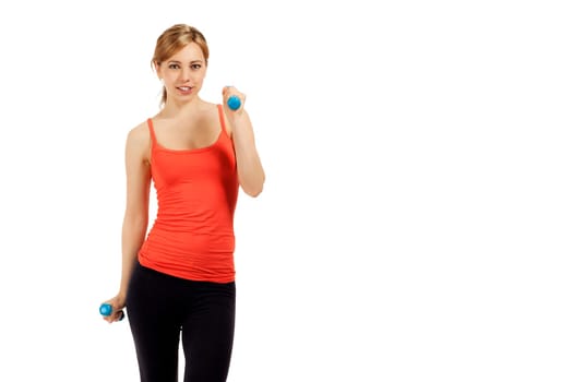Pretty young sportswoman exercising with dumbbells against white background