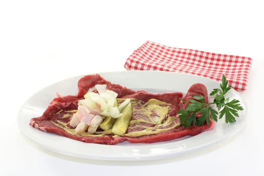raw beef roulade with bacon,onion and cucumber