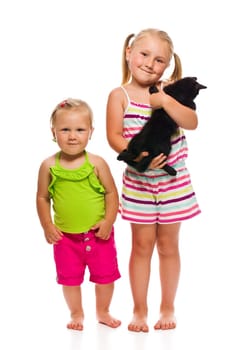 Two sister with kitty. Studio shot.