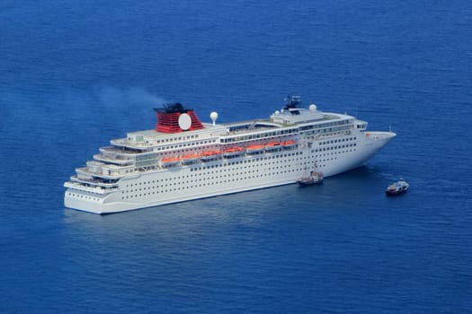 Big cruise ship and two small boats on the Aegean sea, Greece