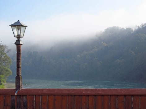 Lantern on the Inn bridge in Wasserburg am Inn,morning fog over the river