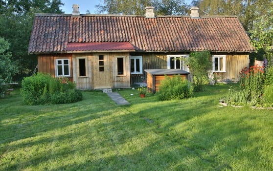 Aged house in the middle of beautiful garden