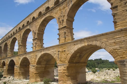 The Pont du Gard is an ancient Roman aqueduct bridge that crosses the Gardon River in southern France
