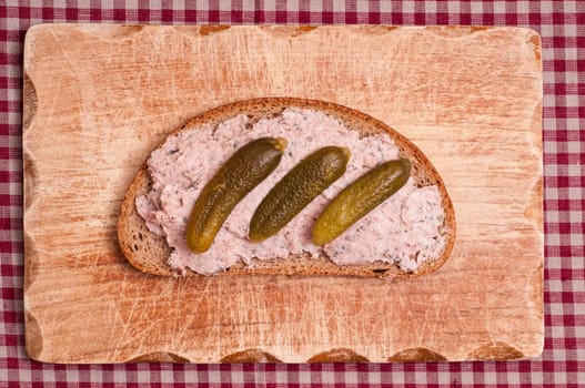 Sausage bread with pickles on a snack board