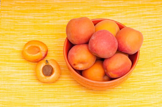 Apricot and apricot kernel on yellow background