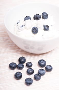 Blue blueberries with quark in portrait format