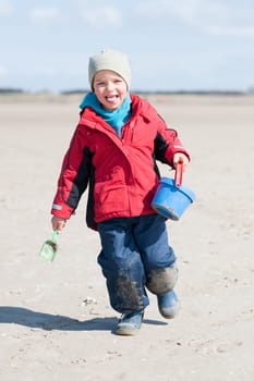 Toddler running on the beach